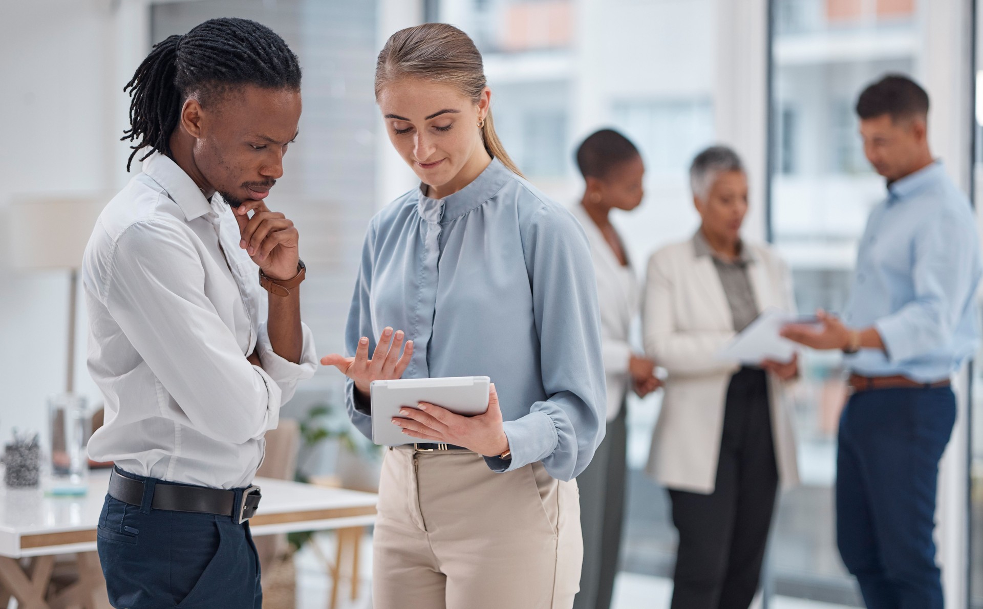 Business people, tablet and collaboration, thinking or planning of marketing ideas, website design and choice. Professional employees in office on digital technology, agency solution or brainstorming